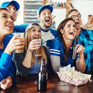  group of friends having beers while betting on a sports game in a bar